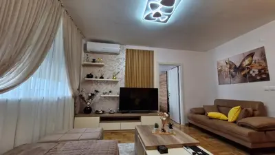 a living room with a couch and a television at Gracia apartman in Vrnjci