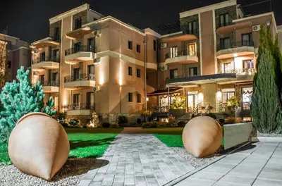 a large building with a lawn in front of it at Apartman Tomić Vrnjacka Banja in Vrnjci