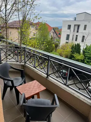 a table and chairs on a balcony with a view at Apartman Tomić Vrnjacka Banja in Vrnjci