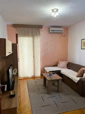 a living room with a couch and a table at Apartman Tomić Vrnjacka Banja in Vrnjci