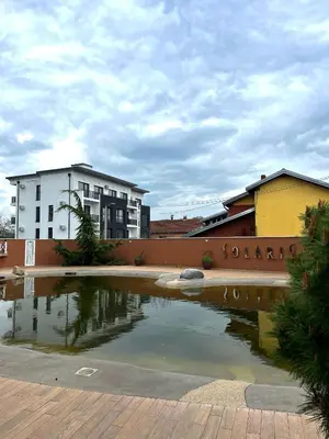 a pool of water in front of a building at Apartman Tomić Vrnjacka Banja in Vrnjci