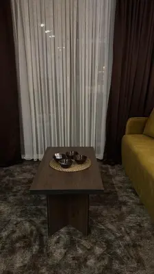 a coffee table in a living room with a couch at SkyNest 605 Apartment in Kopaonik