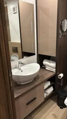 a bathroom with a white sink and a mirror at SkyNest 605 Apartment in Kopaonik