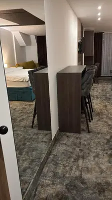 a hotel room with a bed and a table and chairs at SkyNest 605 Apartment in Kopaonik