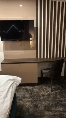 a desk with a television and a chair in a room at SkyNest 605 Apartment in Kopaonik