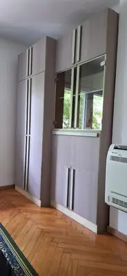 a room with white cabinets and a window at Apartment 4 in Niš