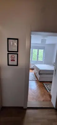a bedroom with a bed and a window at Apartment 4 in Niš
