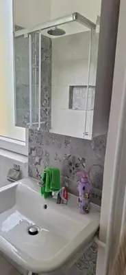 a bathroom with a sink and a mirror at Apartment 4 in Niš