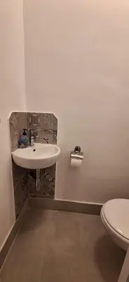 a bathroom with a sink and a toilet at Apartment 4 in Niš