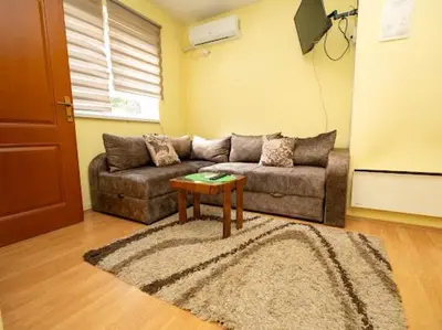 a living room with a couch and a table at Apartmani Votor in Vrnjačka Banja