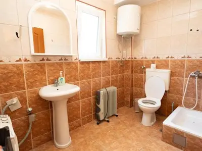 a bathroom with a toilet and a sink and a mirror at Apartmani Votor in Vrnjačka Banja