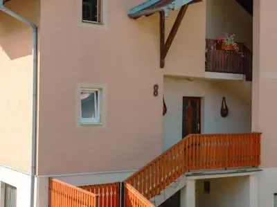 a building with a staircase and a balcony at Apartmani Votor in Vrnjačka Banja