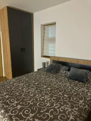 a bedroom with a large bed with two pillows at Primo apartmani in Mirovo
