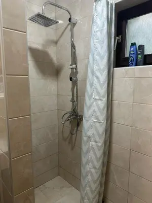 a shower with a glass door in a bathroom at Primo apartmani in Mirovo
