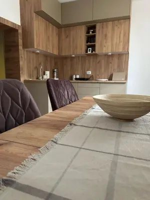 a wooden table with chairs and a bowl on top at Primo apartmani in Mirovo
