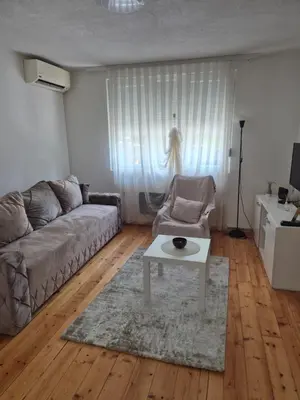 a living room with a couch and a table at Studio VA2016 in Kruševac