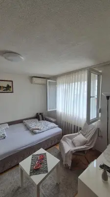 a hotel room with two beds and a table at Studio VA2016 in Kruševac