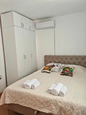 a bedroom with a bed with towels on it at Apartman-Stan in Jagodina