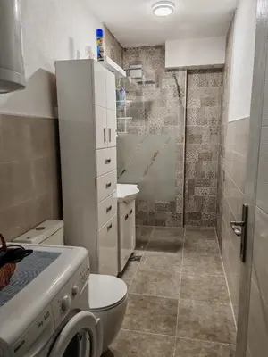 a small bathroom with a toilet and a shower at Apartman-Stan in Jagodina