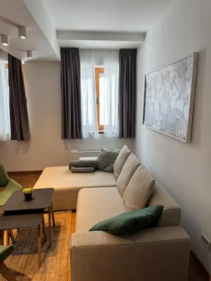 a living room with a couch and a table at Apartman Vila Jaram, Kopaonik in Kopaonik