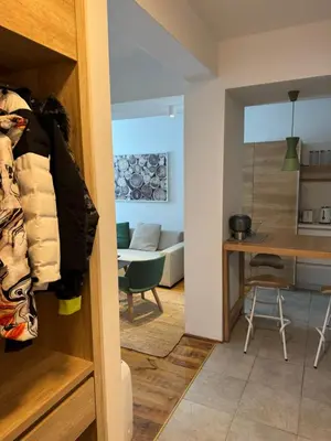a room with a kitchen and a living room at Apartman Vila Jaram, Kopaonik in Kopaonik