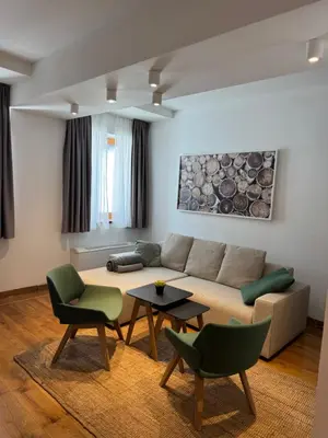 a living room with a couch and chairs and a table at Apartman Vila Jaram, Kopaonik in Kopaonik