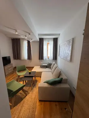 a living room with a couch and a table at Apartman Vila Jaram, Kopaonik in Kopaonik