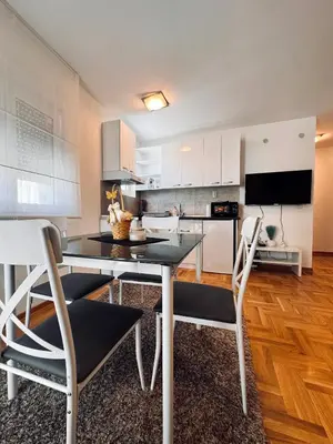 a kitchen with a dining table and two chairs at Azure in Vrnjačka Banja