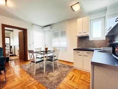 a kitchen and dining room with a table and chairs at Azure in Vrnjačka Banja