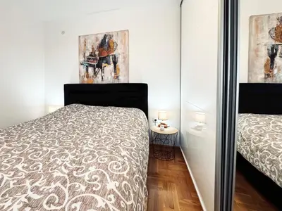 a bedroom with a bed and a mirror at Azure in Vrnjačka Banja