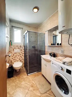 a bathroom with a shower and a toilet and a sink at Azure in Vrnjačka Banja
