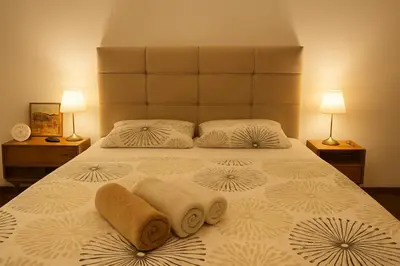 a bedroom with a large bed with towels on it at Garden Lux Grujić Apartmani in Krivi Vir