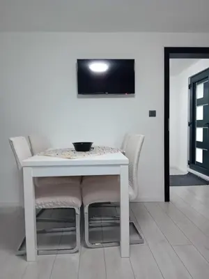 a white table and chairs in a room at Sofora