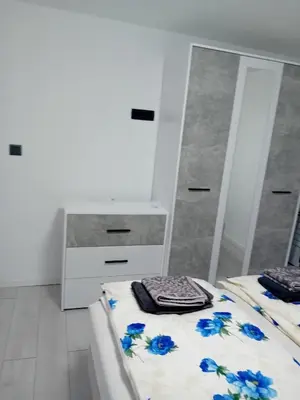 a bedroom with two beds and a mirror at Sofora