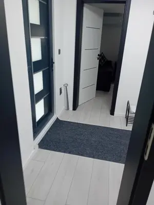 a hallway with a door and a rug in a room at Sofora