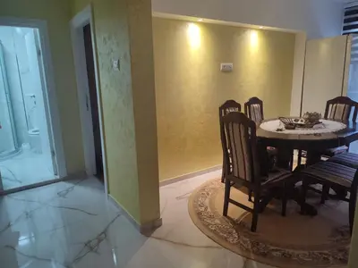 a dining room with a table and four chairs at Apartman Orhideja in Knjazevac.