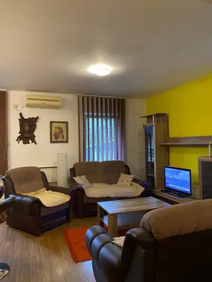 a living room with two couches and a tv at Apartman Katić in Vrnjačka Banja
