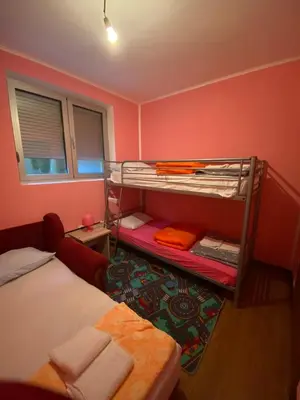 a bedroom with two bunk beds and a window at Apartman Katić in Vrnjačka Banja