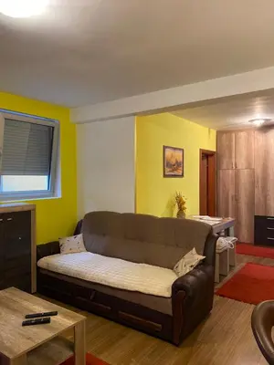 a living room with a couch and a table at Apartman Katić in Vrnjačka Banja