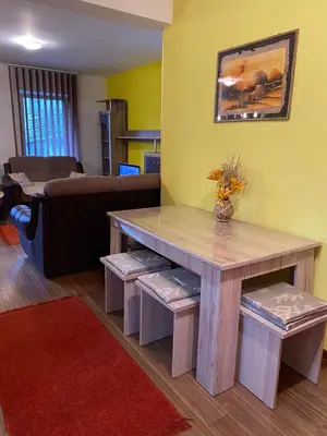 a living room with a table and a couch at Apartman Katić in Vrnjačka Banja