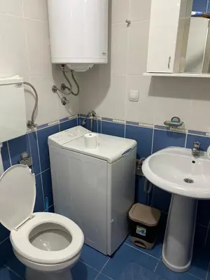 a small bathroom with a toilet and a sink at Apartman Katić in Vrnjačka Banja