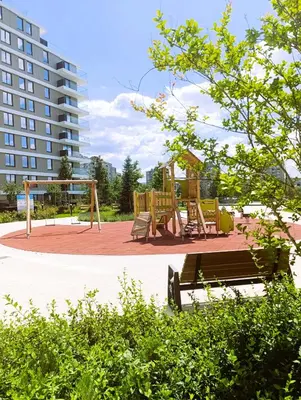 a park with a bench and a playground at LanDan Planet - free parking in Niš