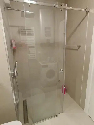 a shower stall with a toilet in a bathroom at LanDan Planet - free parking in Niš