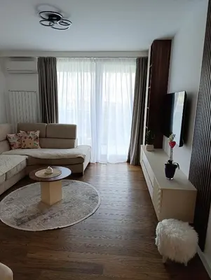 a living room with a couch and a table at LanDan Planet - free parking in Niš