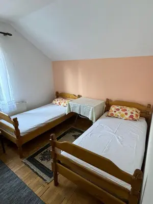 a room with two beds in a room at Apartmani Rada in Prolomska Banja