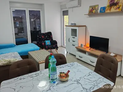 a living room with a table with a bottle on it at You See Gold app in Pojate