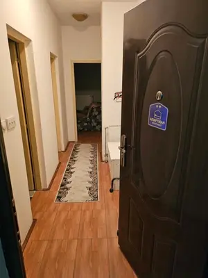 a door with a sign on it in a hallway at Apartman K&M in Vranje