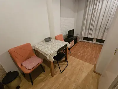 a small room with a table and chairs and a television at Apartman K&M in Vranje