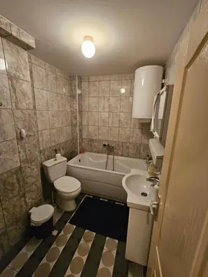 a bathroom with a toilet and a tub and a sink at Apartman K&M in Vranje