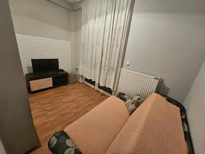 a living room with a couch and a television at Apartman K&M in Vranje